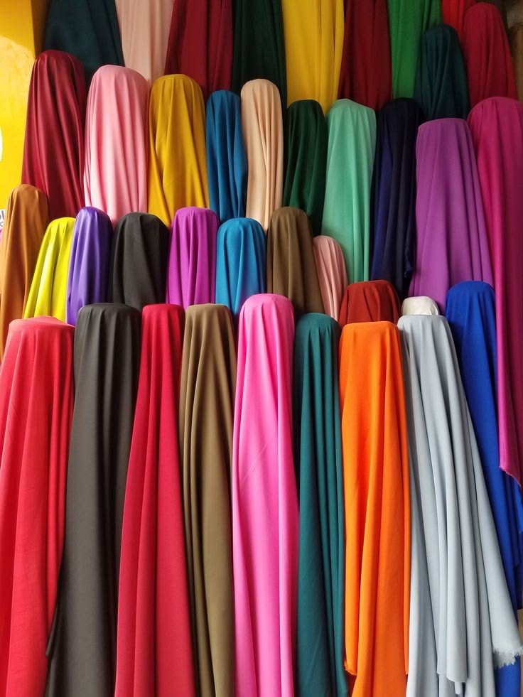 Rolls of colorful premium cotton fabric on display