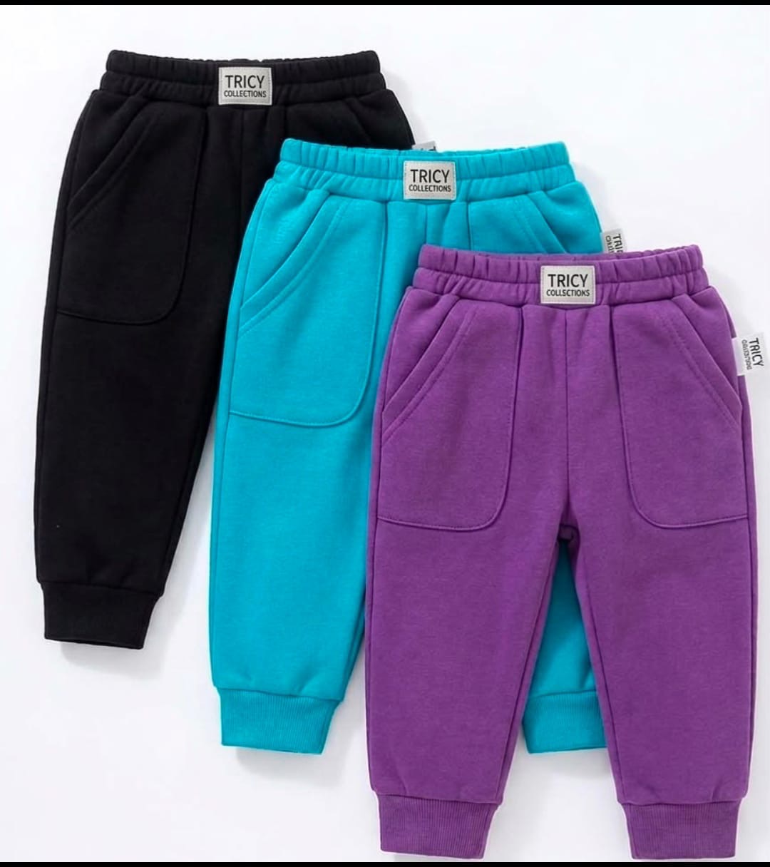 Three pairs of kids fleece joggers in black, teal and purple