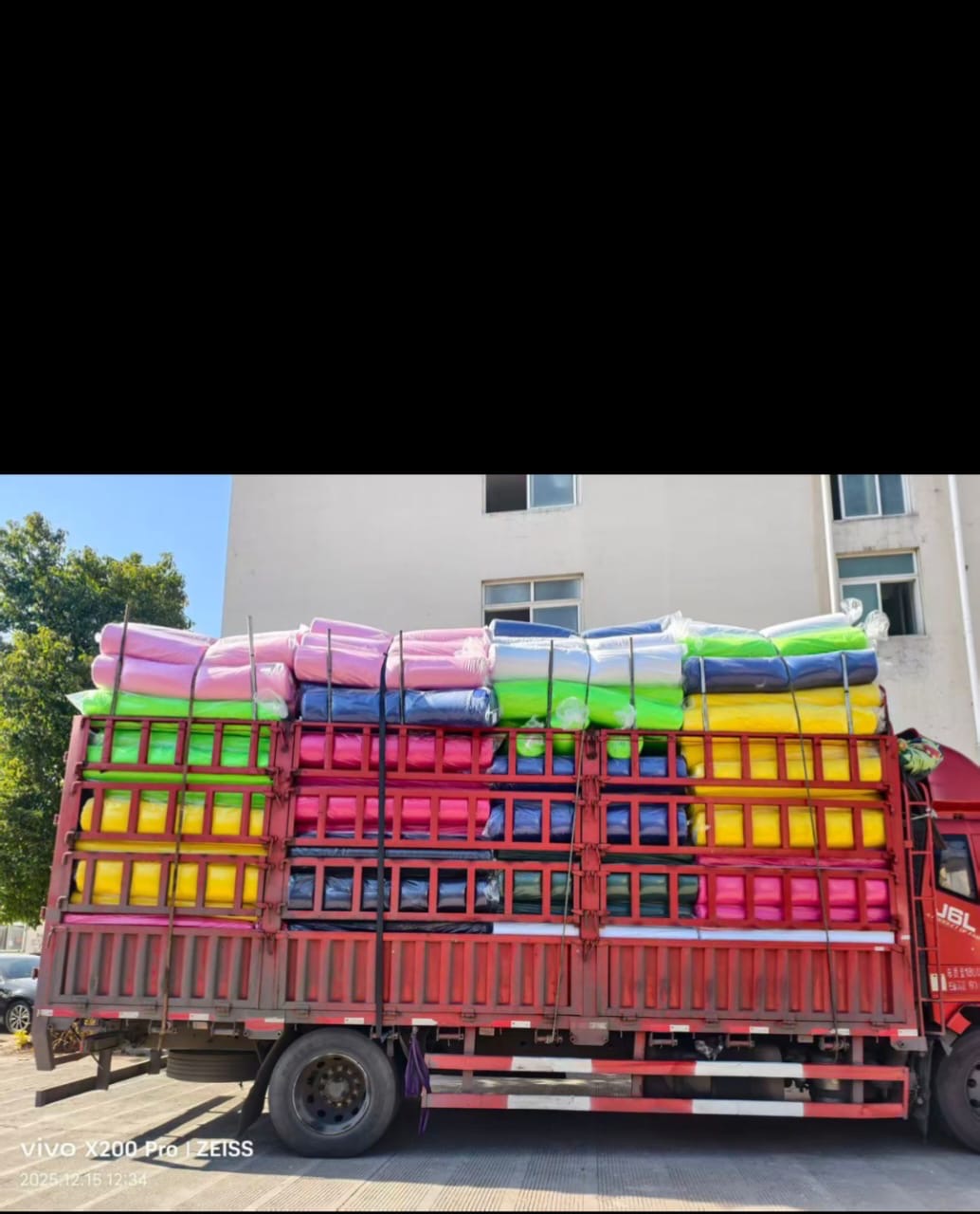 Delivery truck loaded with baled textile materials ready for dispatch