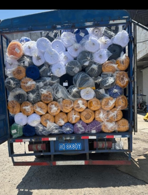 Delivery truck loaded with Royal Queen fabric bales