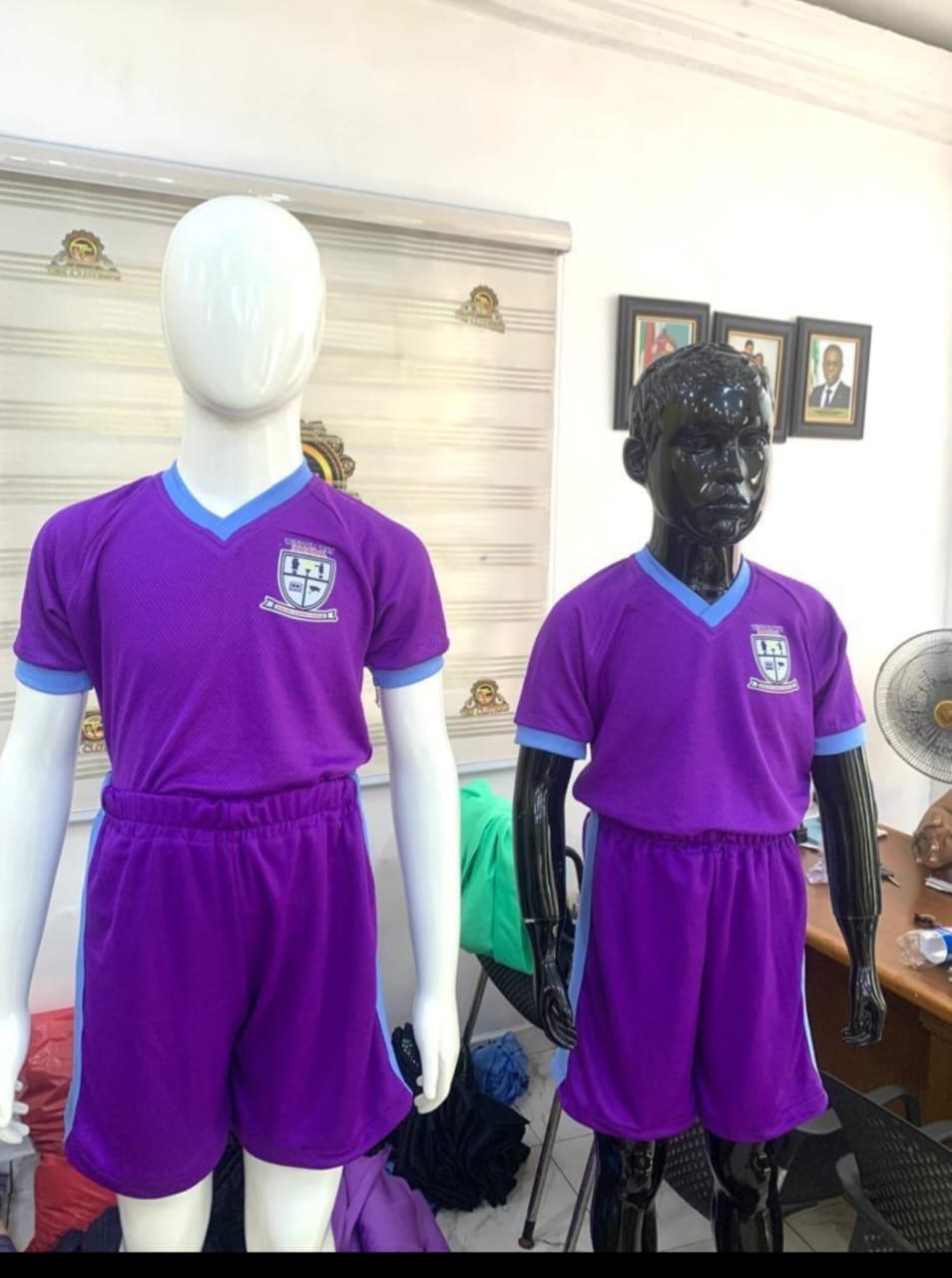 Custom-branded purple school jerseys and shorts on mannequins
